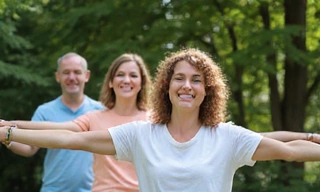 A group of smiling people exercising together, symbolizing wellness programs